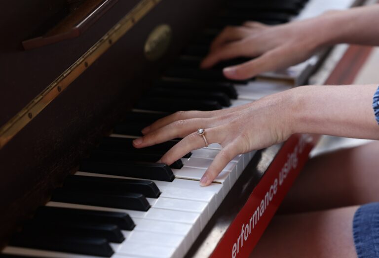 Hands playing the piano